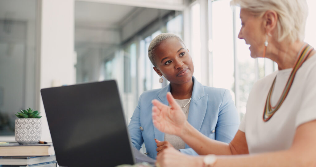 Business woman, teamwork and laptop for advice, support and Human Resources planning in office meeting. Professional HR manager, executive and people talking, training and internship management